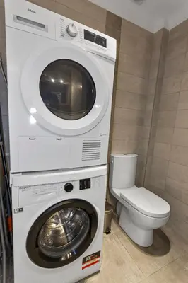 a washer and dryer in a bathroom with a toilet at Le Carnot - HYPERCENTRE - Cosy & Climatisation in Cannes
