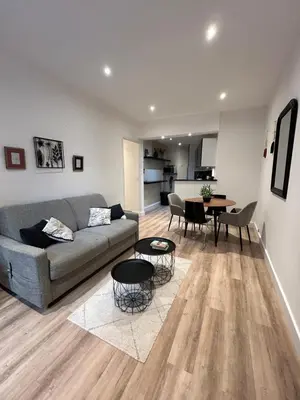 a living room with a couch and a table at 2P 40m2 -Cannes centre- Palais des festivals - in Cannes