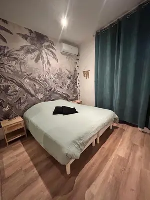 a bedroom with a bed with a painting on the wall at 2P 40m2 -Cannes centre- Palais des festivals - in Cannes