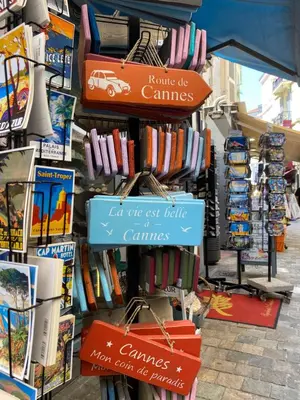a store with a bunch of signs on the wall at 2P 40m2 -Cannes centre- Palais des festivals - in Cannes