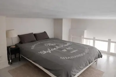 a bed with words written on it in a bedroom at Studio chic rénové à 5 min du Palais & de la Croisette Cannes in Cannes