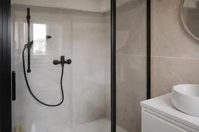 a shower with a glass door in a bathroom at Studio chic rénové à 5 min du Palais & de la Croisette Cannes in Cannes