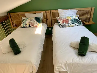 two beds sitting next to each other in a room at Maison de village Cannes Le Suquet in Cannes