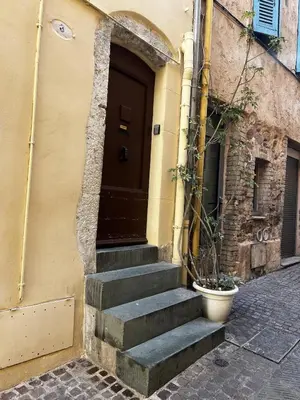 a building with a door and stairs in front of it at Maison de village Cannes Le Suquet in Cannes