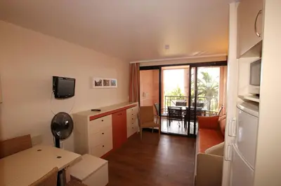 a room with a kitchen and a living room at Flo & Rose Azur - Duplex vue mer terrasses piscine jardins parking in Cannes