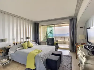 a bedroom with a large bed and a large window at FRGK 