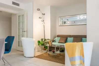 a living room with a couch and a table at Palm Beach - swimming pool - beach at few steps in Cannes