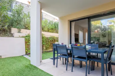 a dining room with a blue table and chairs at Palm Beach - swimming pool - beach at few steps in Cannes