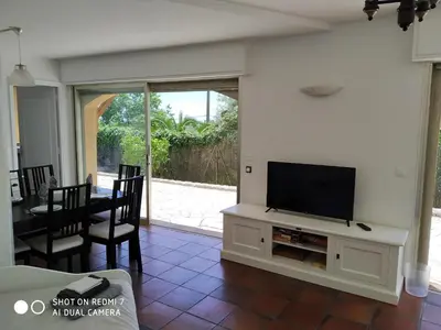 a living room with a flat screen tv on a entertainment center at Rez-de-villa Mougins in Mougins