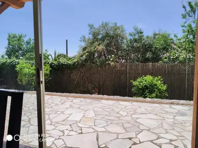 a patio with a stone floor and a fence at Rez-de-villa Mougins in Mougins