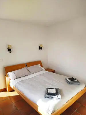 a bedroom with a bed with two books on it at Rez-de-villa Mougins in Mougins