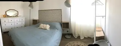 a bedroom with a blue bed and a mirror at Magnifique appartement pied dans l'eau in Cannes
