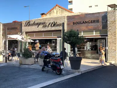 a store with a scooter parked in front of it at Magnifique appartement pied dans l'eau in Cannes