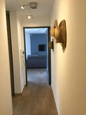 a hallway with a hat hanging on a wall at Magnifique appartement pied dans l'eau in Cannes
