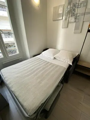 a hospital bed in a room with two pillows at SMART STUDIO in Cannes