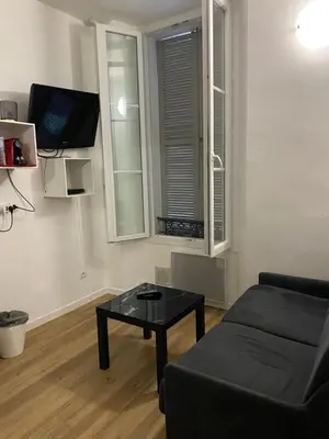 a living room with a couch and a table at SMART STUDIO in Cannes