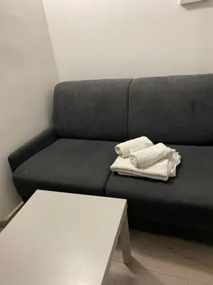 a black couch with two white towels on it at SMART STUDIO in Cannes