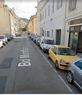 a yellow car parked on the side of a street at SMART STUDIO in Cannes