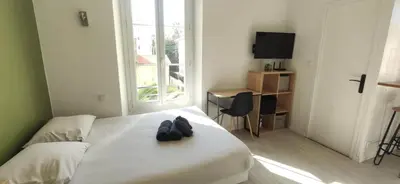 a hotel room with a bed with shoes on it at APPARTEMENT CANNES MONTFLEURY in Cannes