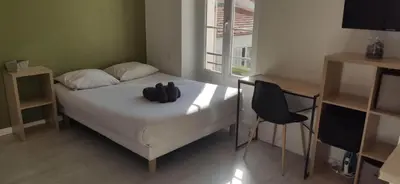 a bedroom with a bed with black objects on it at APPARTEMENT CANNES MONTFLEURY in Cannes