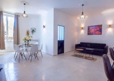 a living room with a couch and a table and chairs at Grand appartement 4 pièces centre de Cannes in Cannes