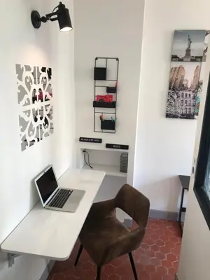 a room with a desk with a laptop and a chair at Appartement Suquet Forville in Cannes