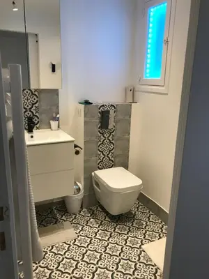 a bathroom with a toilet and a sink at Appartement Suquet Forville in Cannes