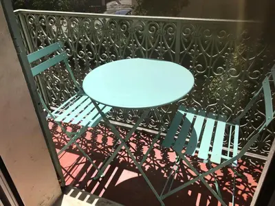 a blue table and two chairs on a balcony at Appartement Suquet Forville in Cannes
