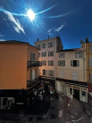 a group of buildings with the sun in the sky at 1-bedroom apt 5 minutes from the Congress Center in Cannes