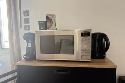 a microwave sitting on top of a counter at 1-bedroom apt 5 minutes from the Congress Center in Cannes
