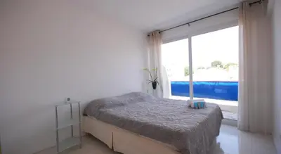 a bedroom with a bed and a large window at T3 Pte Croisette Vue mer Plage à 100m in Cannes
