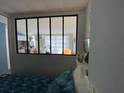 a bedroom with a window and a couch in a room at Studio 30 M2 Hyper centre, Neuf, Parking Gratuit, 3 Étoiles in Cannes