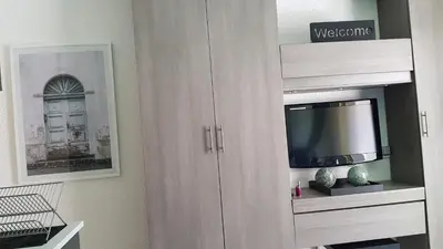 a white cabinet with a television in it at Studio Center Cannes grande Terasse in Cannes