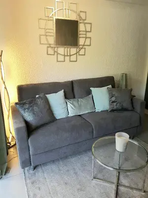 a living room with a couch and a glass table at Studio Center Cannes grande Terasse in Cannes