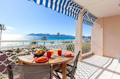 a table on a balcony with a view of the ocean at Résidence Saint Rémy 2 in Cannes