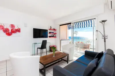 a living room with a couch and a table at Résidence Saint Rémy 2 in Cannes