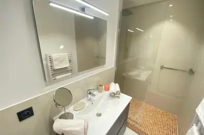 a bathroom with a sink and a mirror and a shower at Renovated 2 bedrooms - Boulevard de la Croisette in Cannes