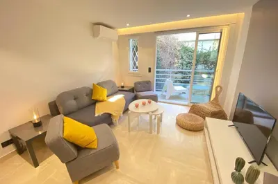 a living room with a couch and a table at Renovated 2 bedrooms - Boulevard de la Croisette in Cannes