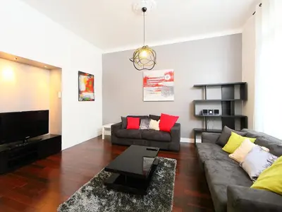 a living room with a couch and a tv at Apartment Villa Chalmette by Interhome in Cannes
