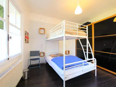 a bedroom with two bunk beds and a chair at Holiday Home Villa Esmeralda by Interhome in Cannes