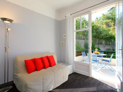 a living room with a couch and a sliding glass door at Holiday Home Villa Esmeralda by Interhome in Cannes