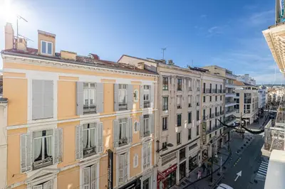 a row of buildings on a street in a city at L'ESCAPADE CITADINE avec 2 chambres, proche de la Croisette, des plages et du Palais in Cannes