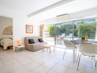 a living room with a couch and a table at Apartment Cannes Bay-1 by Interhome in Cannes
