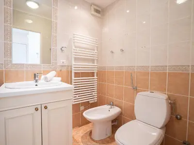 a bathroom with a toilet and a sink and a mirror at Apartment Cannes Bay-1 by Interhome in Cannes