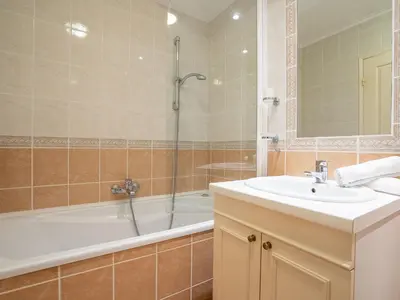 a bathroom with a sink and a tub and a shower at Apartment Cannes Bay-1 by Interhome in Cannes