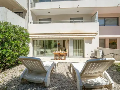 two chairs and a table in front of a house at Apartment Cannes Bay-1 by Interhome in Cannes