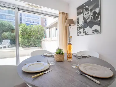 a dining room table with plates and wine glasses at Apartment Cannes Bay-1 by Interhome in Cannes