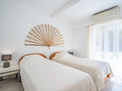 two beds in a white room with a window at Apartment Cannes Bay-1 by Interhome in Cannes