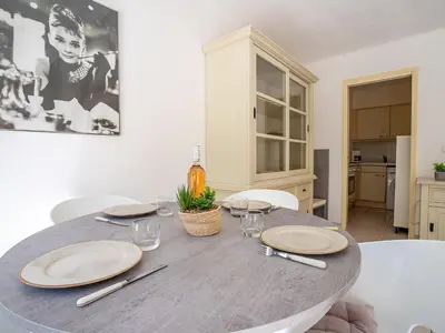 a dining room with a table with plates on it at Apartment Cannes Bay-1 by Interhome in Cannes