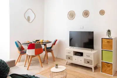 a living room with a table and a tv at C11 - 1 BDR Rue Meynadier 5min Palais Festivals & Sea - AC in Cannes